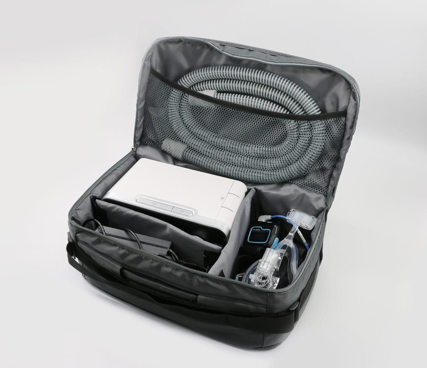 The Resvent iBreeze 30STA Bi-Level machine and its power supply components securely packed inside the padded compartments of a black Resvent travel bag with a shoulder strap.