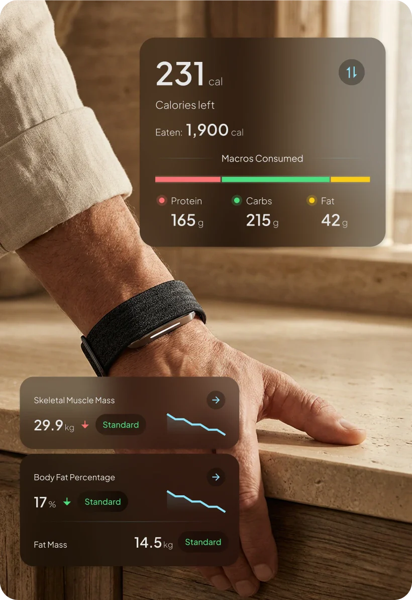 Hand wearing a hume 2 smartwatch with fitness and health data displayed on a wooden surface