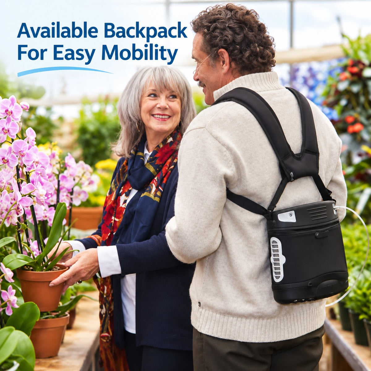 A man wearing a black backpack with the liberty 2 portable oxygen concentrator and cannula in a garden center, standing next to a woman holding potted pink flowers. Blue text in the top left reads 'Available Backpack For Easy Mobility'.