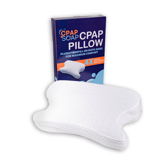 CPAP Soap Adjustable CPAP pillow with side cutouts, displayed in front of its blue and orange retail packaging.