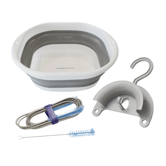 CPAP Soap Clean Start Kit flat lay showing all three components: collapsible wash basin with 1-gallon fill line, two-piece flexible tube brush set, and hose hanger with suction cup and top hook