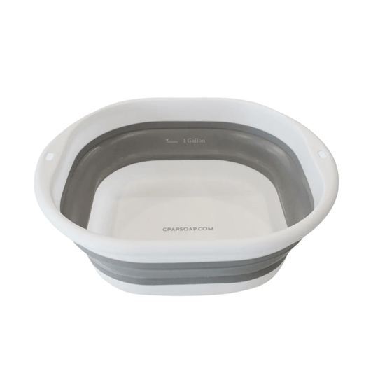 White and grey collapsible CPAP wash basin fully expanded, showing the interior 1-gallon water fill line.
