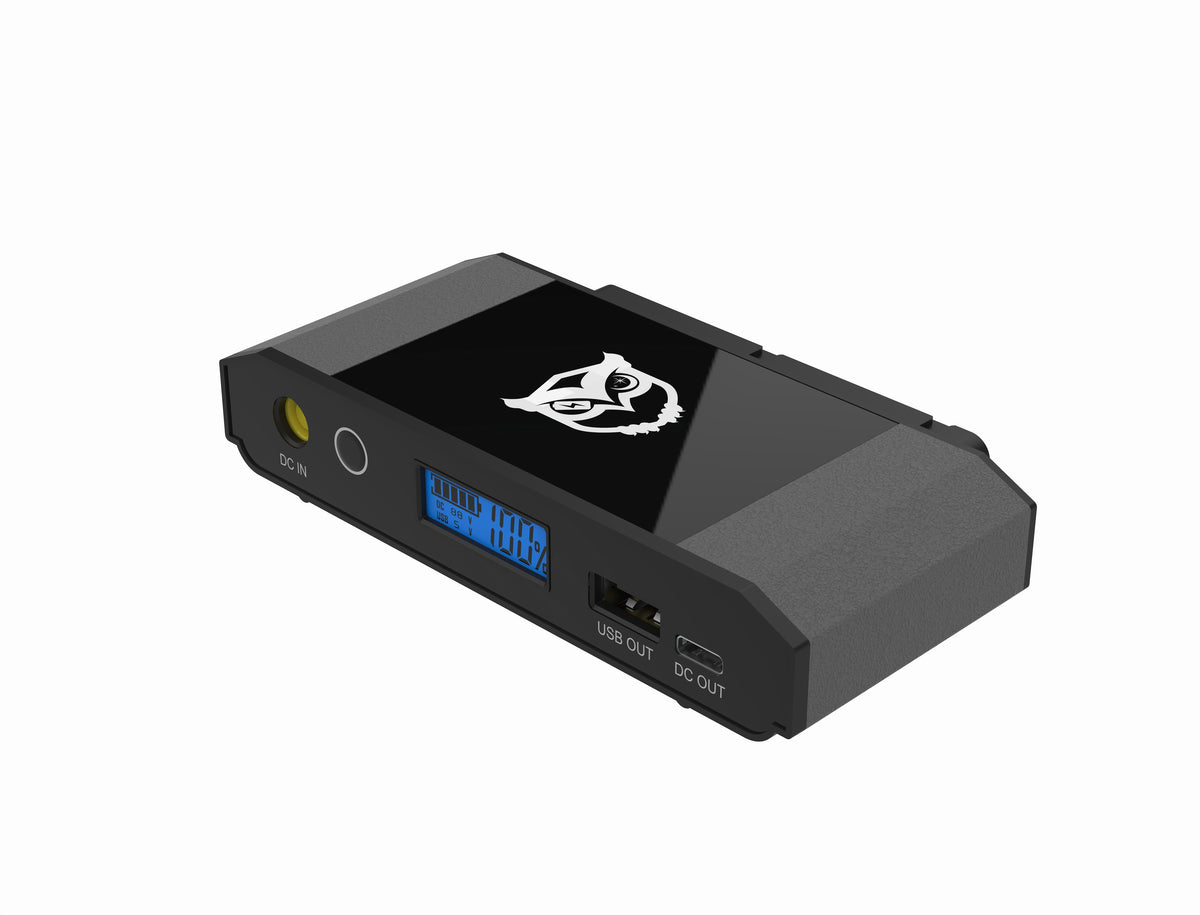 A black Niteowl CPAPportable power bank with a glossy black top panel featuring a white stylized logo, a blue digital display screen, and multiple ports including USB-C, USB 2.0, and DC OUT, shown on a plain white background. Control panel off of battery. 