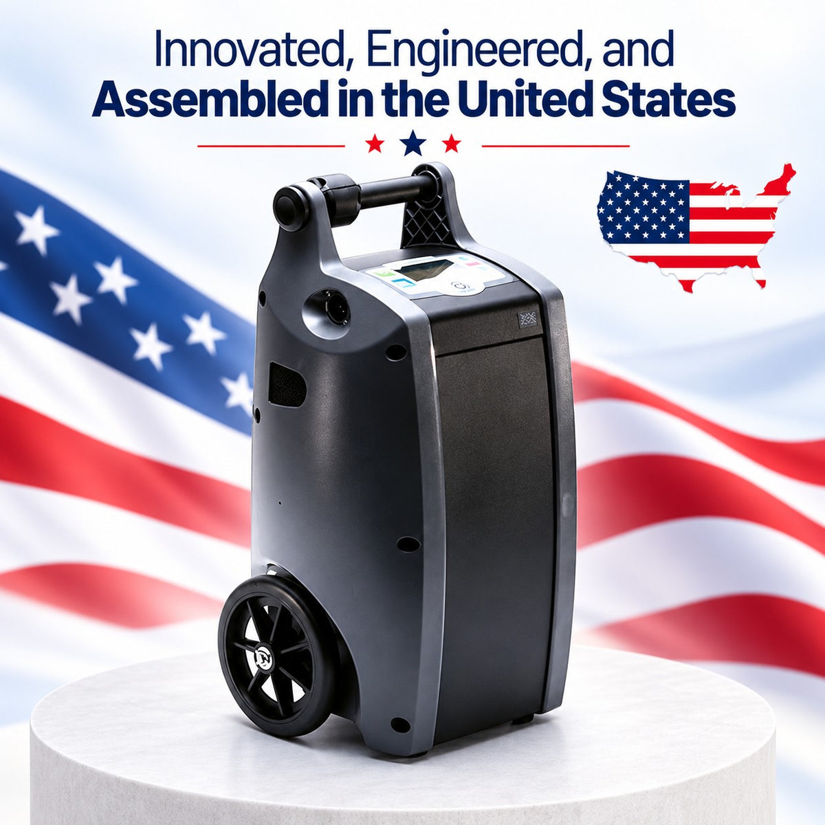 A dark gray O2 Concepts Oxilfe Independence with a handle and front control panel, displayed on a white pedestal against a blurred American flag background. Text at the top reads 'Innovated, Engineered, and Assembled in the United States' with a small U.