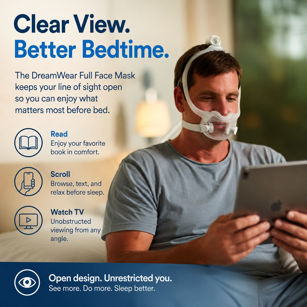 A man wearing a DreamWear full face mask for sleep, shown in a bedroom setting while holding a tablet. The image includes marketing text highlighting the mask's clear view and better bedtime benefits.