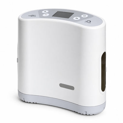 A liberty 2 portable oxygen concentrator device in white and light gray, featuring a digital display screen and control buttons on top, shown against a plain white background.