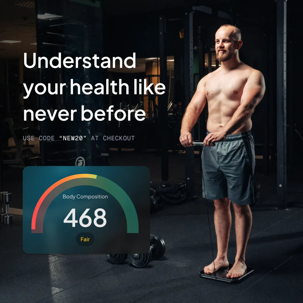 Man standing on a scale with body composition results displayed, in a gym setting.