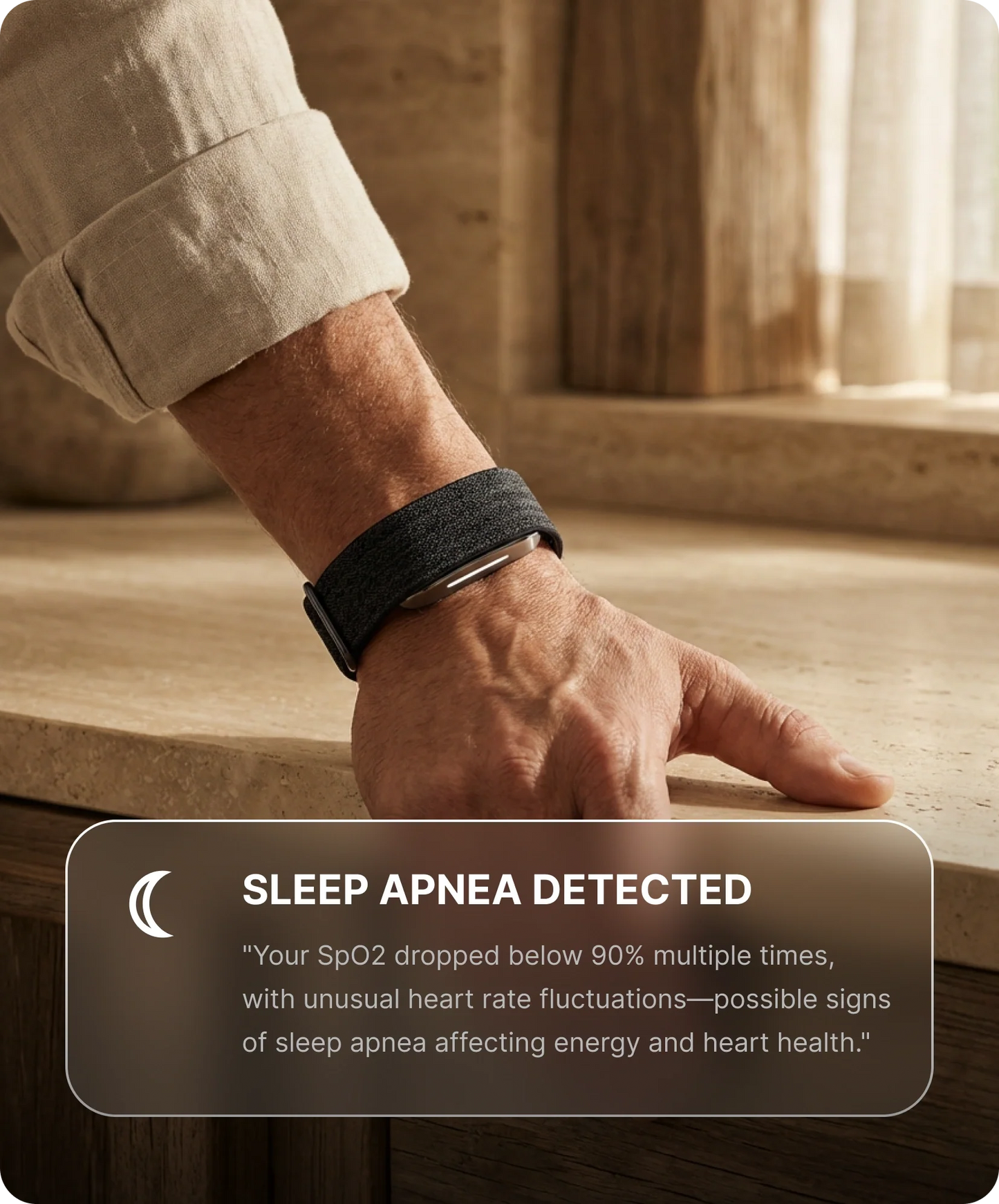 Person wearing a hume 2 band with a notification about sleep apnea detected, on a wooden surface.