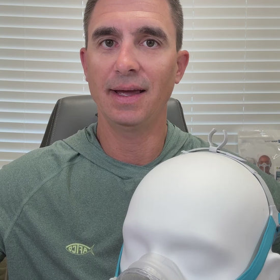 Product feature video for the Fisher & Paykel Nova Nasal CPAP mask. The video highlights its compact design, featuring a 360-degree swivel, a top-of-head tube clip for active sleepers, and a removable quiet-flow diffuser. It showcases the mask's stability and its soft "floating" nasal cushion designed to reduce pressure on the bridge of the nose.