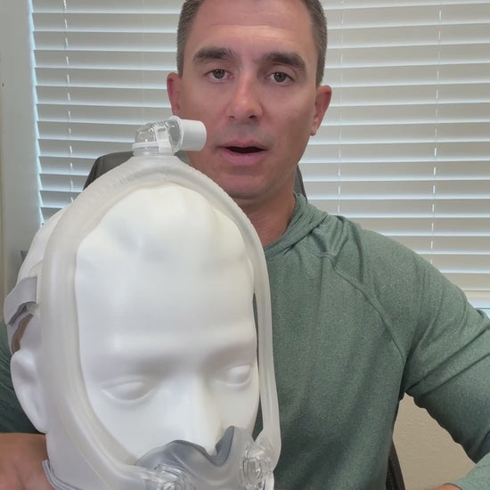 A demonstration of the AirTouch F30i mask components being assembled. Shown are the under-the-nose ComfiSoft cushion, the hollow "30i" frame for airflow, and the top-mounted swivel elbow. The video highlights the tool-free disassembly process for better mask hygiene.